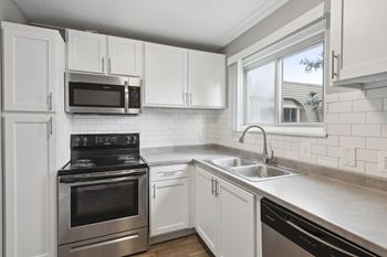 Kitchen with white cabinets and stainless steel appliances